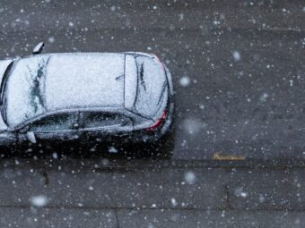 Black car on the road under the snow in spring in New Zagreb, Croatia
